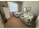 Cozy bedroom featuring twin beds, a chest of drawers, and a large window at 7360 Talon Bay Dr, North Port, FL 34287