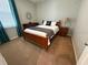 This bright, carpeted bedroom features a full-sized bed and a large window for natural light at 7360 Talon Bay Dr, North Port, FL 34287