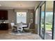 Bright dining area with a chandelier and sliding glass doors overlooking the backyard at 7360 Talon Bay Dr, North Port, FL 34287