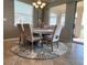 Charming dining room with a round table, elegant chairs, and a view of the serene lake at 7360 Talon Bay Dr, North Port, FL 34287