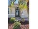 Inviting front entrance with a charming palm tree and decorative landscaping at 7360 Talon Bay Dr, North Port, FL 34287