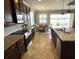 Bright kitchen featuring stainless steel appliances, granite countertops, and an adjacent dining area with a lake view at 7360 Talon Bay Dr, North Port, FL 34287