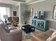 Comfortable living room featuring a plush sofa set, modern console, and a large window at 7360 Talon Bay Dr, North Port, FL 34287