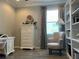 Comfortable office with a patterned armchair, built-in shelves, and a large window with neutral drapes at 7360 Talon Bay Dr, North Port, FL 34287