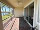 Covered screened patio with brick flooring, outdoor seating, and a view of a lake at 7360 Talon Bay Dr, North Port, FL 34287