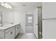 This bathroom features a double vanity and glass shower at 7424 Cabin Ln, Sarasota, FL 34240