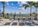 Lounge chairs are arranged neatly near a lake view, perfect for relaxation and enjoying the waterfront at 7424 Cabin Ln, Sarasota, FL 34240