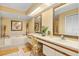 Bright bathroom featuring double sinks, soaking tub with tile surround, and natural light at 7639 Fairway Woods Dr # 605, Sarasota, FL 34238