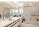 Well-lit bathroom with glass-enclosed shower, stylish fixtures, and plenty of vanity space at 7639 Fairway Woods Dr # 605, Sarasota, FL 34238