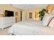 Comfortable main bedroom featuring a dresser, TV, and ensuite bathroom at 7639 Fairway Woods Dr # 605, Sarasota, FL 34238