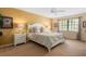 A spacious bedroom offers comfort and style with neutral tones and a large window at 7639 Fairway Woods Dr # 605, Sarasota, FL 34238