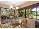 Bright dining area with table, chairs and large window view and access to the outdoor patio for a light and airy atmosphere at 7639 Fairway Woods Dr # 605, Sarasota, FL 34238
