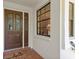 Inviting entryway features a decorative wood door and a window allowing natural light to flow in at 7639 Fairway Woods Dr # 605, Sarasota, FL 34238