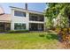 Two story home with a lush, green lawn and a second story screened in porch at 7639 Fairway Woods Dr # 605, Sarasota, FL 34238