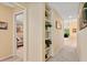 Hallway with built-in bookshelves, leading to the living room and additional rooms at 7639 Fairway Woods Dr # 605, Sarasota, FL 34238