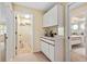 Hallway featuring built-in cabinetry and access to the laundry room and the bathroom at 7639 Fairway Woods Dr # 605, Sarasota, FL 34238