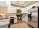The kitchen is a chef's dream, featuring stainless steel appliances, modern lighting and tile floor at 7639 Fairway Woods Dr # 605, Sarasota, FL 34238