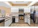 This efficient kitchen has stainless steel appliances, white cabinets and a bright, cheerful decor at 7639 Fairway Woods Dr # 605, Sarasota, FL 34238