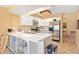 Bright kitchen featuring white cabinetry, stainless steel appliances, and tile flooring at 7639 Fairway Woods Dr # 605, Sarasota, FL 34238