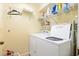 Bright laundry room with appliances, shelving, and ample storage space at 7639 Fairway Woods Dr # 605, Sarasota, FL 34238