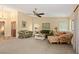 Bright living room with neutral carpet, ceiling fan and comfortable seating area, creating a cozy atmosphere at 7639 Fairway Woods Dr # 605, Sarasota, FL 34238