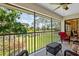 A screened in patio offers views of the manicured golf course and community landscaping at 7639 Fairway Woods Dr # 605, Sarasota, FL 34238