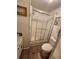 A bathroom featuring a shower with sliding glass doors, a toilet, and a rug at 808 53Rd E Ave # 229, Bradenton, FL 34203