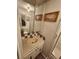 A bathroom with a tiled sink, toilet, shower and decorative wall art at 808 53Rd E Ave # 229, Bradenton, FL 34203