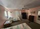 This bedroom features two twin beds, a ceiling fan, and a TV on a dresser at 808 53Rd E Ave # 229, Bradenton, FL 34203