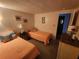 Bright bedroom with two twin beds, side table, and dresser at 808 53Rd E Ave # 229, Bradenton, FL 34203