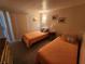 Cozy bedroom featuring two twin beds and decorative wall art at 808 53Rd E Ave # 229, Bradenton, FL 34203