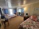 Bedroom with two twin beds, seating, mirrored closet and natural light at 808 53Rd E Ave # 229, Bradenton, FL 34203