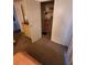 Bedroom closet featuring carpet floor and open doors to an ironing board at 808 53Rd E Ave # 229, Bradenton, FL 34203