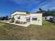 Side view of a charming home showcasing a well-kept lawn and mature trees at 808 53Rd E Ave # 229, Bradenton, FL 34203