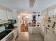 Well-organized kitchen flowing into dining area, featuring essential appliances and ample storage at 808 53Rd E Ave # 229, Bradenton, FL 34203