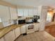Efficient kitchen featuring wooden countertops, tiled floors, and a range of essential appliances at 808 53Rd E Ave # 229, Bradenton, FL 34203