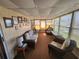A bright sunroom with wicker furniture, wall decor, and lots of windows at 808 53Rd E Ave # 229, Bradenton, FL 34203