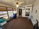 Sunroom with an ceiling fan, multiple windows and a door to the kitchen at 808 53Rd E Ave # 229, Bradenton, FL 34203