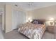Comfortable bedroom featuring light walls, tile floors, closet, and ceiling fan at 909 68Th W St, Bradenton, FL 34209