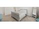 Bedroom with plush carpet, soft lighting, and a comfortable gray bed frame, mirror and adjacent bathroom at 9725 Last Light Gln, Parrish, FL 34219