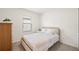 Bedroom featuring a window, carpet floors, a closet, and a bed with gold accents and a cushioned headboard at 9725 Last Light Gln, Parrish, FL 34219