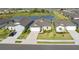 Aerial view of home's exterior featuring a well-manicured lawn, lake view, and neutral color palette at 9725 Last Light Gln, Parrish, FL 34219