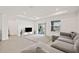 Bright living room with recessed lighting, tile floors, a comfortable gray sectional sofa, and large windows at 9725 Last Light Gln, Parrish, FL 34219