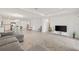 Open floor plan with tile flooring, a gray sectional sofa, and an adjacent kitchen and dining area at 9725 Last Light Gln, Parrish, FL 34219