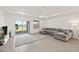 Bright living room featuring recessed lighting, a sliding door to the backyard, and stylish gray sectional sofa at 9725 Last Light Gln, Parrish, FL 34219