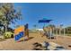 View of a community playground with climbing equipment, swings, and a sun shade at 9725 Last Light Gln, Parrish, FL 34219