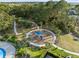 Aerial view of community playground surrounded by sidewalks, trees, and landscaping at 9725 Last Light Gln, Parrish, FL 34219