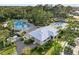 Aerial view of community pool and splashpad, surrounded by lush landscaping and mature trees at 9725 Last Light Gln, Parrish, FL 34219