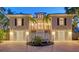 Charming two-story home at dusk, with a brick driveway and well-lit entryway at 5024 Commonwealth Dr, Sarasota, FL 34242