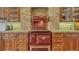 Close up of the antique-style range with brick surround and custom wood cabinetry at 5024 Commonwealth Dr, Sarasota, FL 34242